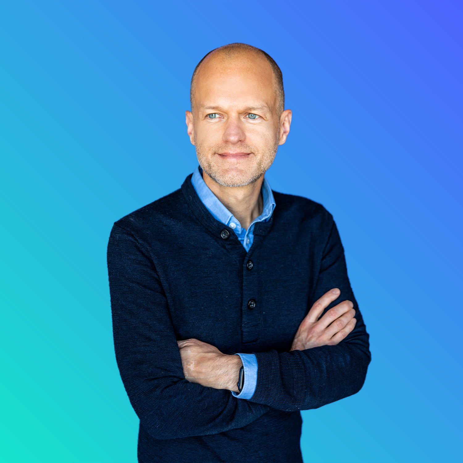 Zac in front of a blue background.